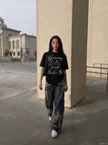 DAXUEN Black short-sleeved t-shirt with graphic text — model photo