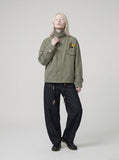 DAXUEN olive green utility jacket with intricate badge — model photo