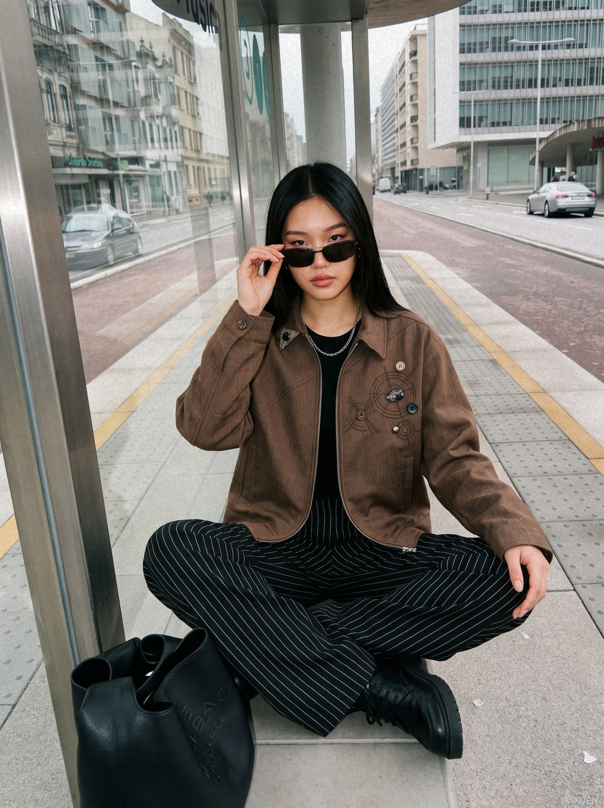 DAXUEN brown oversized jacket with intricate orbital design — model photo