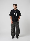 DAXUEN black oversized inverted U-graphic T-shirt — model photo