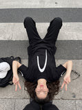 DAXUEN black oversized inverted U-graphic T-shirt — model photo