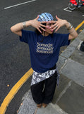 DAXUEN navy blue oversized italicized-serif graphic t-shirt — model photo