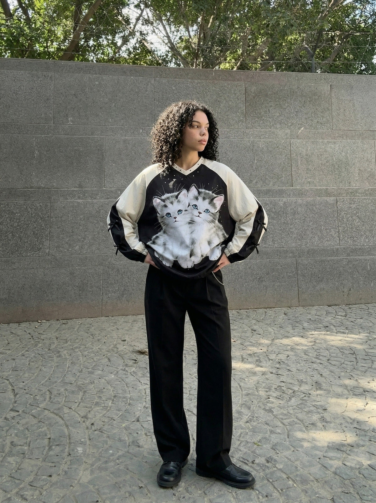 DAXUEN Black oversized pullover with kitten graphic and studs — model photo