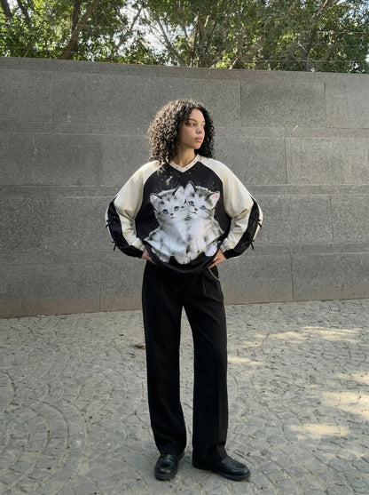 DAXUEN Black oversized pullover with kitten graphic and studs — model photo