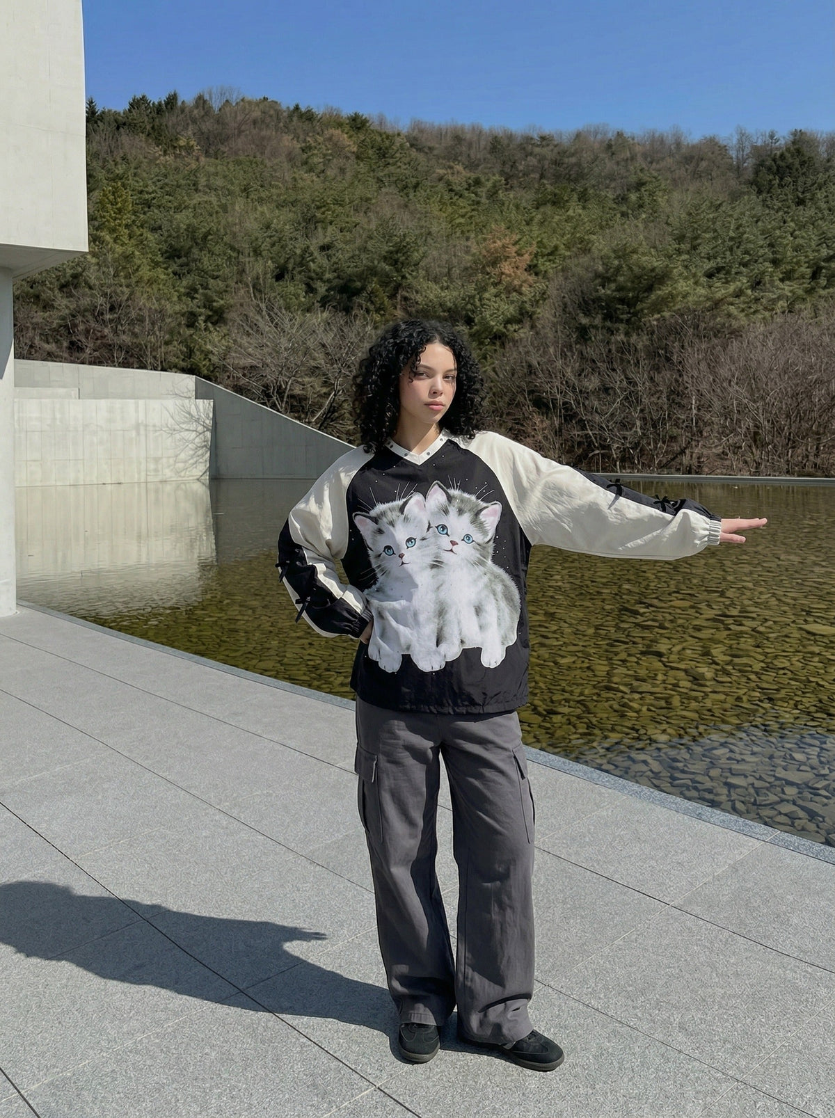 DAXUEN Black oversized pullover with kitten graphic and studs — model photo