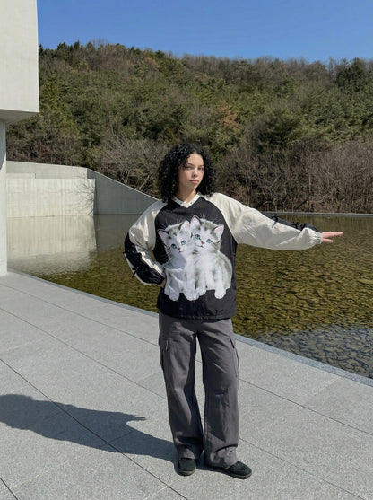 DAXUEN Black oversized pullover with kitten graphic and studs — model photo