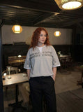 DAXUEN Layered distressed graphic t-shirt with text prints — model photo