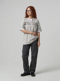 DAXUEN Layered distressed graphic t-shirt with text prints — model photo