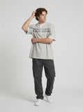 DAXUEN Layered distressed graphic t-shirt with text prints — model photo