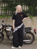 DAXUEN black oversized leopard print collar polo shirt — model photo