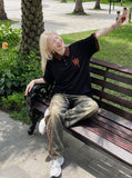 DAXUEN black oversized leopard print collar polo shirt — model photo