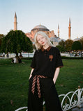 DAXUEN black oversized leopard print collar polo shirt — model photo