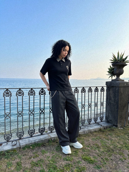 DAXUEN black polo shirt with leopard print collar and cross graphic — model photo