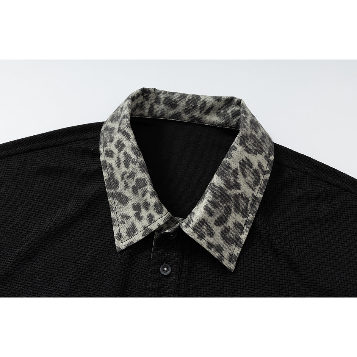DAXUEN black polo shirt with leopard print collar and cross graphic
