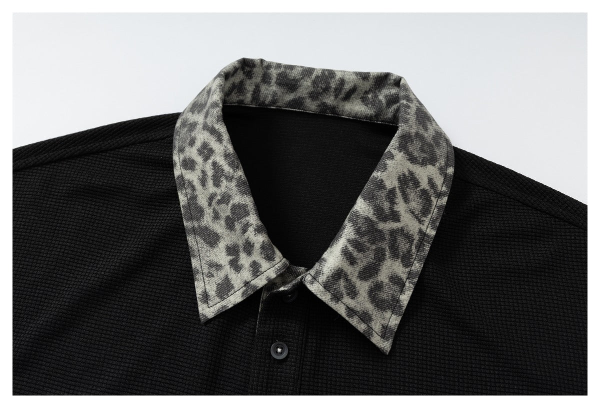 DAXUEN black polo shirt with leopard print collar and cross graphic