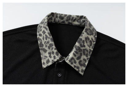 DAXUEN black polo shirt with leopard print collar and cross graphic