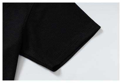 DAXUEN black polo shirt with leopard print collar and cross graphic