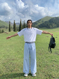 DAXUEN light blue oversized grid casual pants — model photo