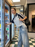 DAXUEN light blue oversized heart-stitched jeans — model photo