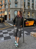 DAXUEN Loose-fitting cargo shorts with distressed graphics — model photo