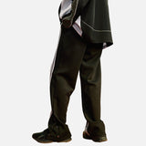 DAXUEN Loose-fitting track pants with snap buttons and stripes — model photo
