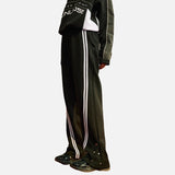 DAXUEN Loose-fitting track pants with snap buttons and stripes — model photo