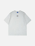 DAXUEN Short-sleeved T-shirt with metallic emblem and pleated details