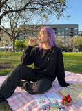 DAXUEN black oversized crewneck sweatshirt with metallic zip pocket — model photo