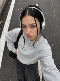 DAXUEN black oversized crewneck sweatshirt with metallic zip pocket — model photo