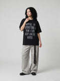 DAXUEN Oversized short-sleeved t-shirt with distressed text print — model photo