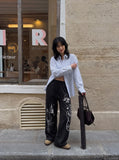 DAXUEN black oversized multi-graphic knit sweatpants — model photo