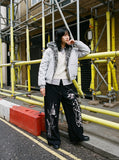 DAXUEN black oversized multi-graphic knit sweatpants — model photo