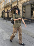 DAXUEN acid-wash multi-panel graphic oversized tee — model photo
