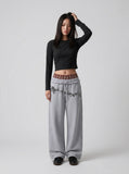 DAXUEN Grey wide-leg sweatpants with musical print and plaid details — model photo