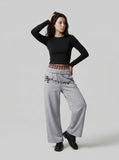 DAXUEN Grey wide-leg sweatpants with musical print and plaid details — model photo