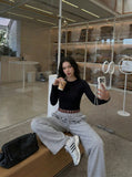 DAXUEN Grey wide-leg sweatpants with musical print and plaid details — model photo