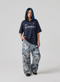 DAXUEN Navy oversized polo shirt with graphics — model photo