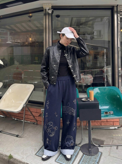 DAXUEN Navy wide-leg sweatpants with embroidered graphics — model photo