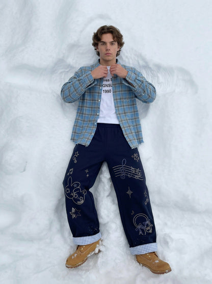DAXUEN Navy wide-leg sweatpants with embroidered graphics — model photo