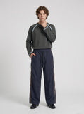 DAXUEN dark navy wide-leg trousers with gold stripes — model photo