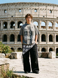 DAXUEN faded grey nine-panel newsprint graphic tee — model photo