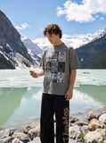 DAXUEN faded grey nine-panel newsprint graphic tee — model photo