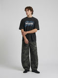 DAXUEN Oversized graphic T-shirt with text and abstract design — model photo