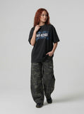 DAXUEN Oversized graphic T-shirt with text and abstract design — model photo