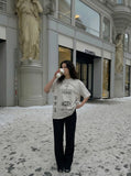 DAXUEN Distressed oversized crew-neck t-shirt with graphic prints — model photo