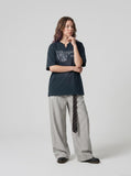 DAXUEN Oversized graphic T-shirt featuring hourglass design — model photo