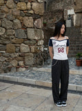 DAXUEN white and navy off-shoulder angelic graphic top — model photo