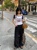 DAXUEN white and navy off-shoulder angelic graphic top — model photo
