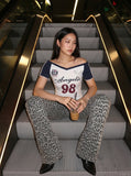 DAXUEN white and navy off-shoulder angelic graphic top — model photo