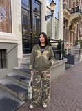 DAXUEN olive camouflage wide-leg pants with pink stripes — model photo